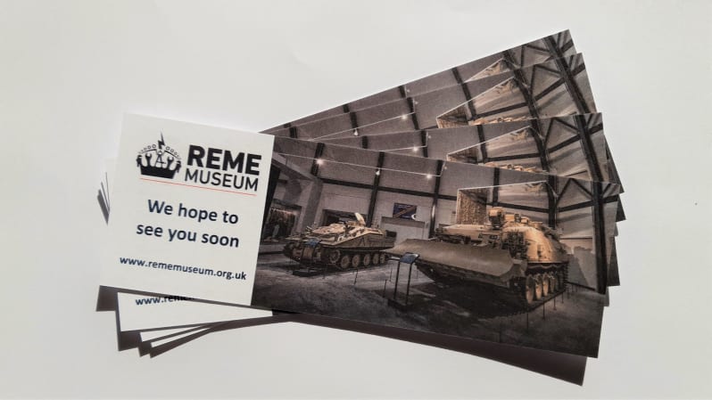 Several bookmarks laid out so that the ones behind are slightly visible in a swivel. Reads "REME Museum We hope to see you soon" with an image of large armoured vehicles in a gallery.
