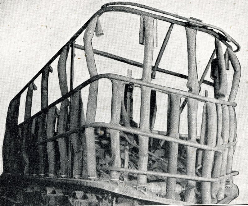 Black and white photo of a cage like frame of flexible tubes.