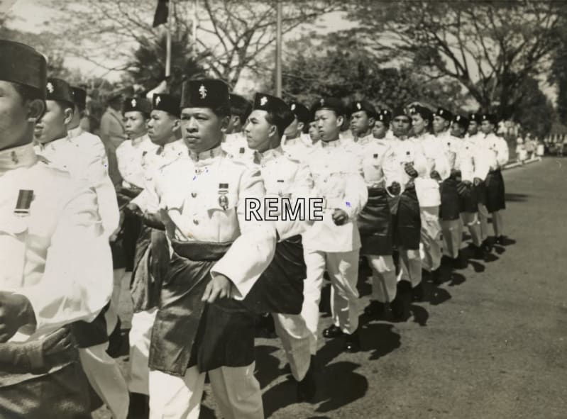 Black and white photograph of Singaporean troops marching outside in a formation.