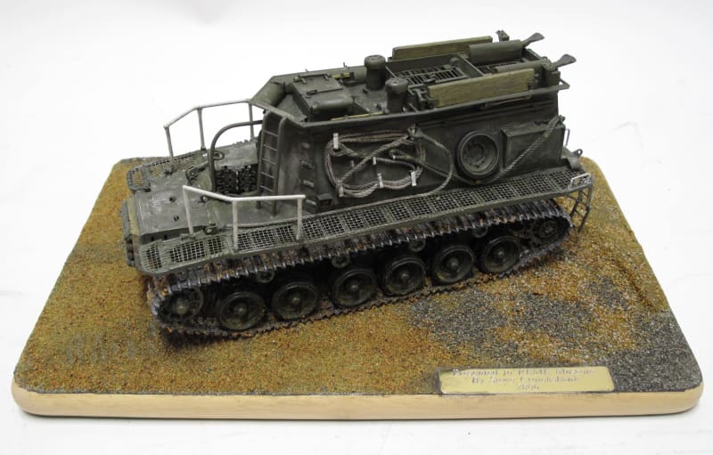 Scale model of an armoured vehicle on a wooden base board.