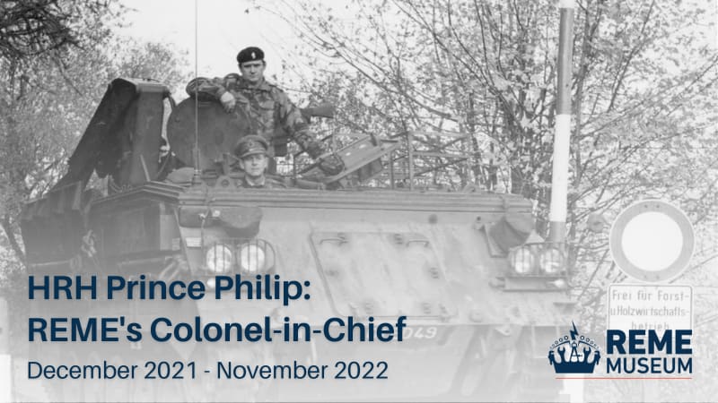 Black and white photo of Prince Philip in armoured vehicle, trees in background and German street sign. Text overlaid reads "HRH Prince Philip: REME's Colonel in Chief, December 2021 - November 2022".