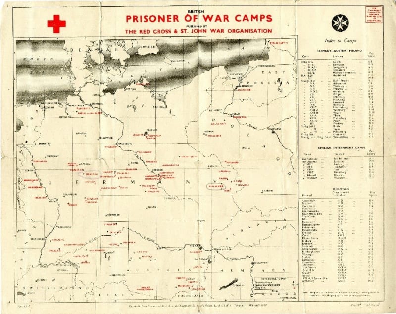 Outline map of Germany, Poland, Austria and surrounding areas printed on paper. Various locations of Prisoner of War camps marked in red on map. Table on right side of map. British Red Cross symbol in top left corner.