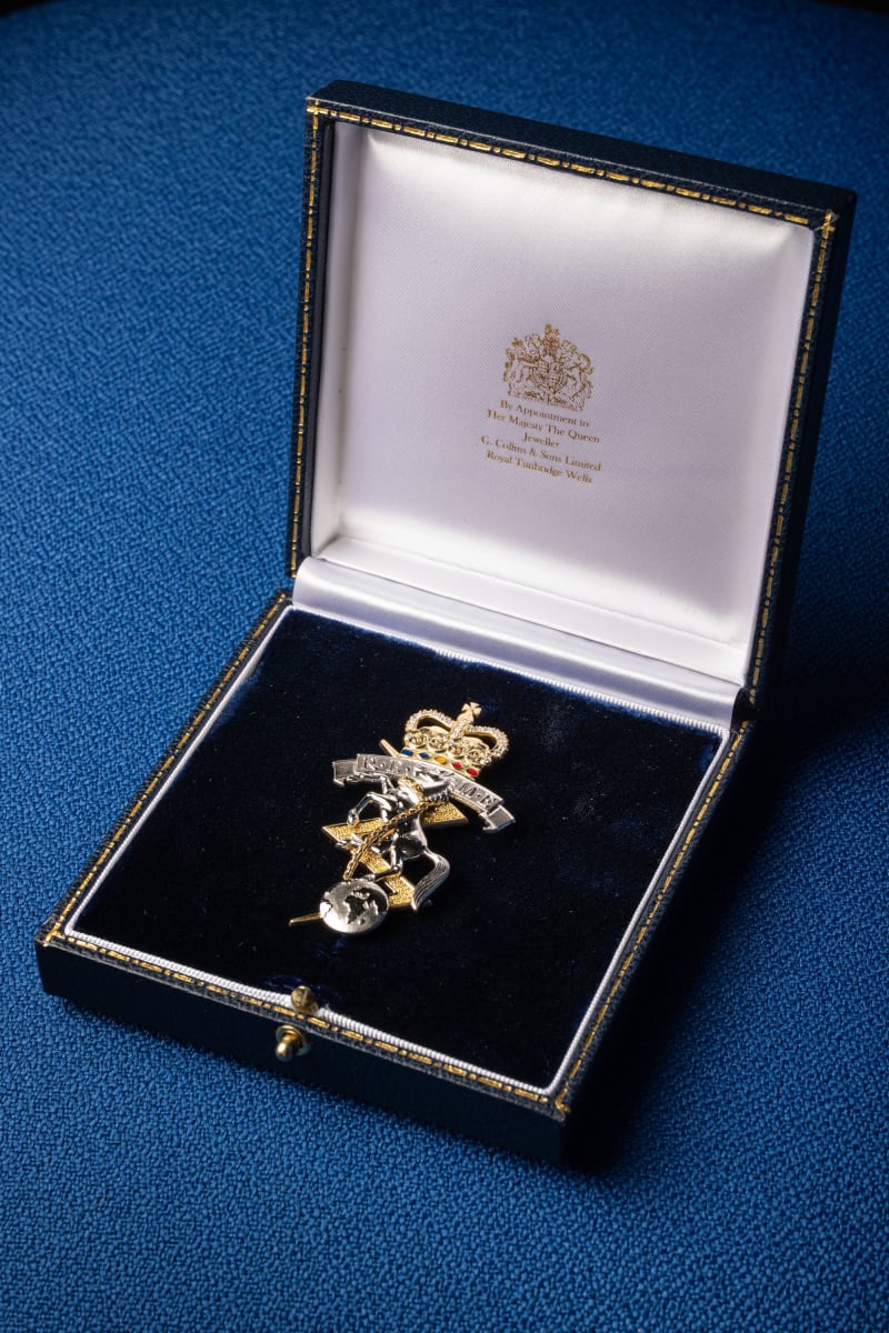 Jewelled brooch in the shape of the REME cap badge presented inside a box with dark velvet cushion and white satin lined lid.