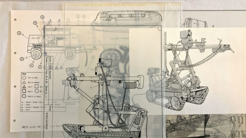Various technical drawings and annotations of tracked machines on sketching paper.