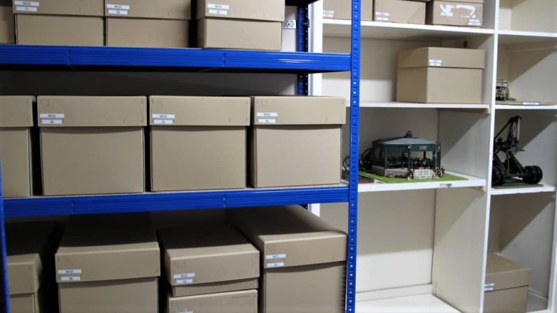 Boxes on shelves in the collections storage room after being processed.