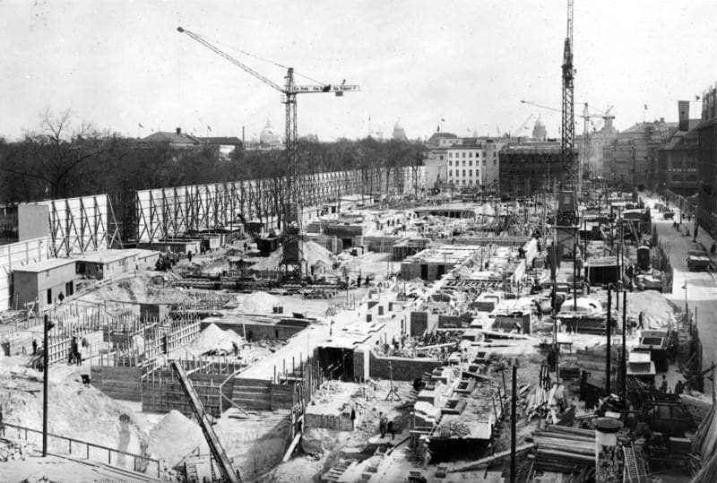 Black and white photograph of a large contsruction site with cranes.