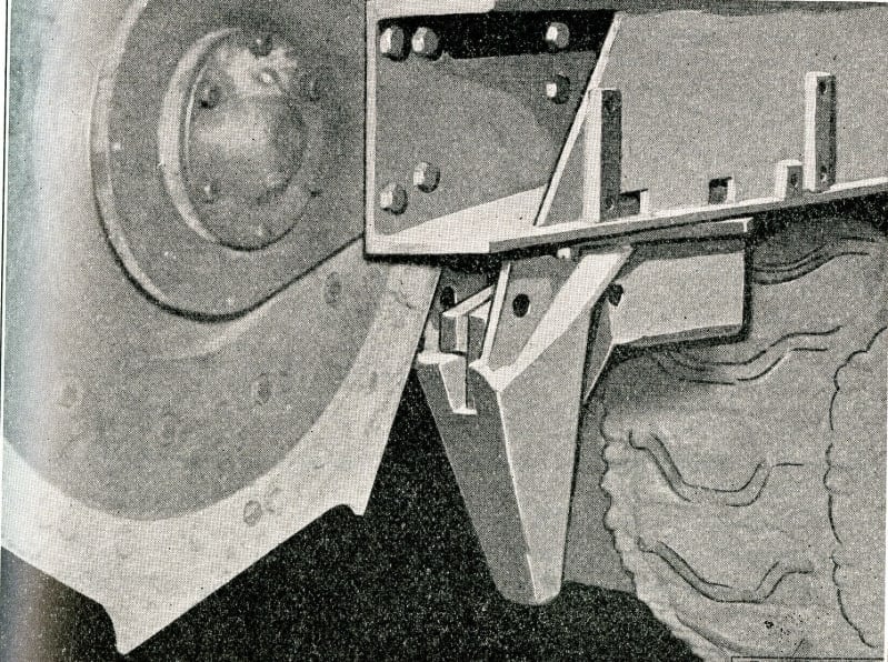 Side view of some mechanical parts, tank track visible in the bottom corner.