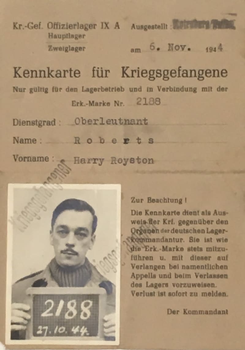 Document in German with a photograph in the bottom corner of a man holding a sign with numbers.