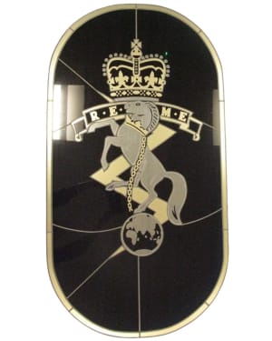 A black glass window with gold coloured REME badge.
