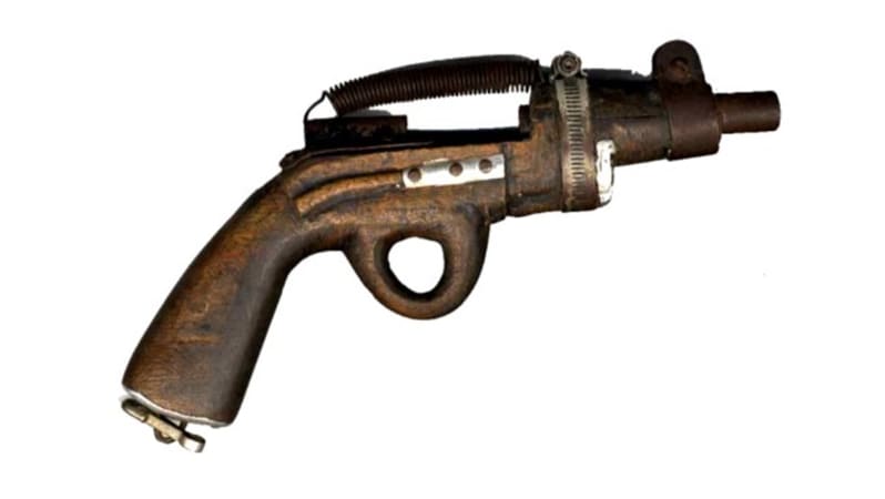 Pistol made from rusty metals. The barrel is made from a spring and the trigger is missing.