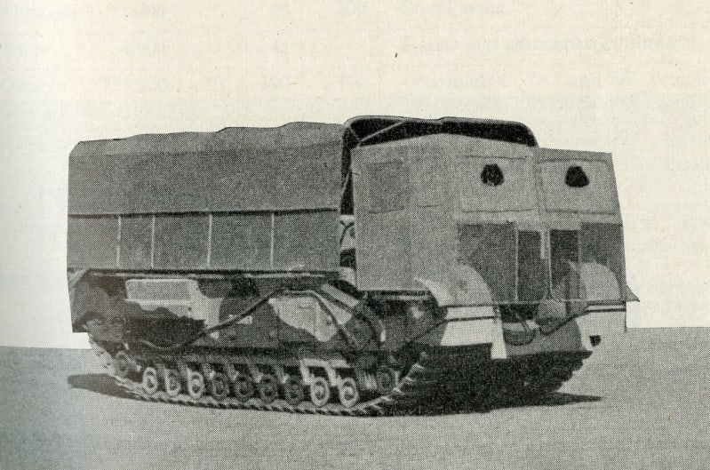 Black and white photo of a tank with material covering the front, side and roof.