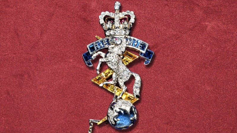 Jewelled brooch in the shape of the REME cap badge with horse chained to the globe wearing a crown, scroll reading " REME " .